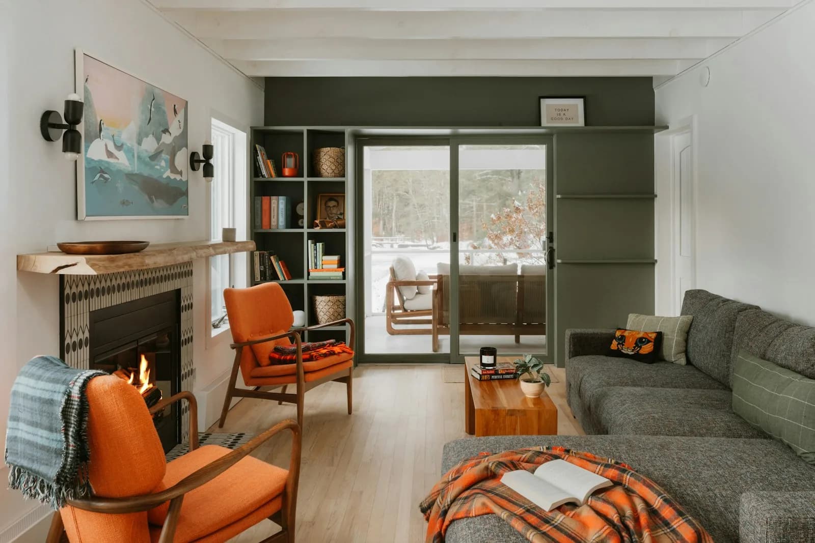 A warm, comfortable living room with a lit fireplace
